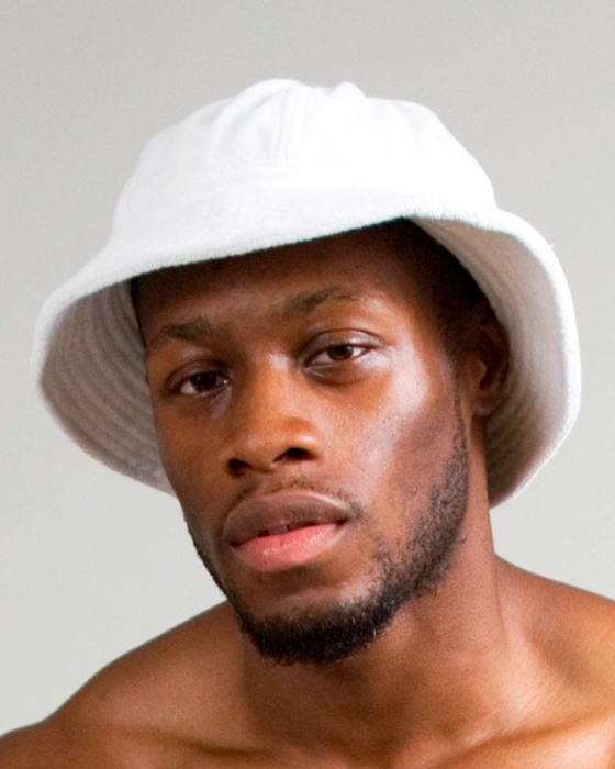 model with beard and white terry cloth hat