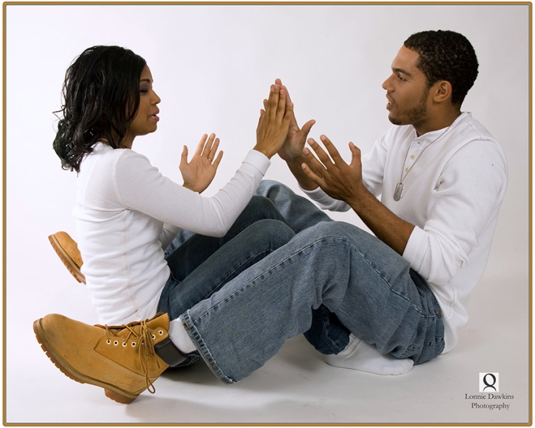 adult engaged couple on floor plying patty cakes